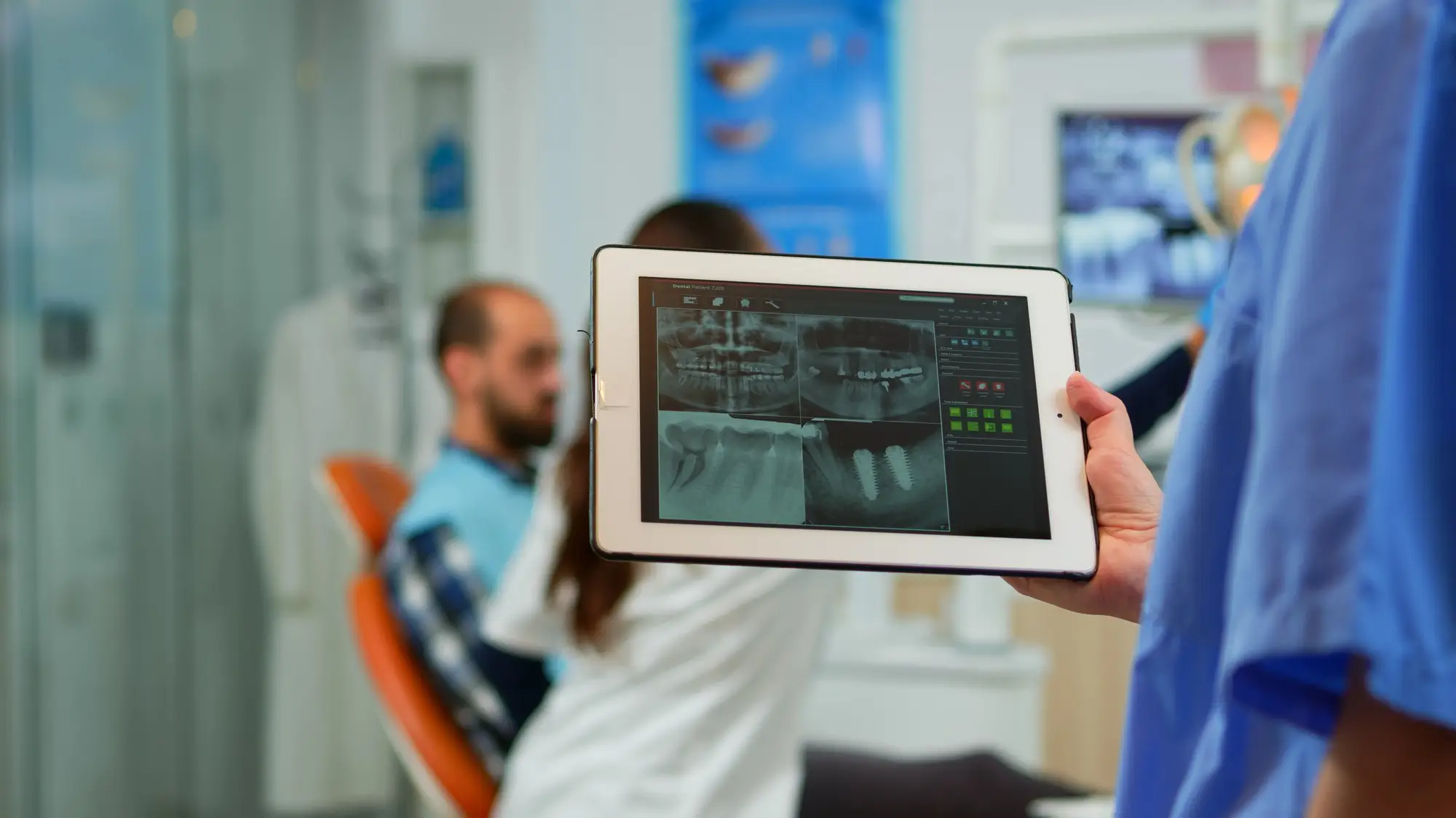 Close up dentist nurse holding tablet with digital radiography Close up dentist nurse holding tablet with digital radiography